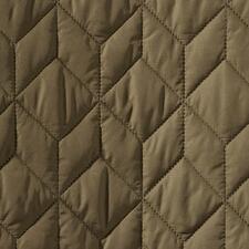 donkergroen Close-up van de stof van een olijfgroene gewatteerde jas.