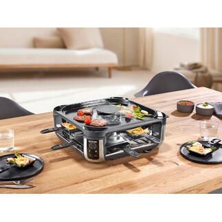 Raclette-grill met ingebouwde rookafzuiging op een gedekte tafel.