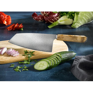 Damast Nakiri-mes op een houten plank, omringd door verse groenten.