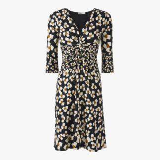 Vooraanzicht van een zwart-witte jersey jurk met abstracte bloemen en een elastische taille.