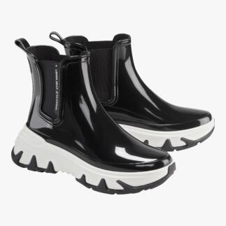 Zwarte Chelsea sneakerboots met witte zolen, paargewijs op een witte achtergrond.