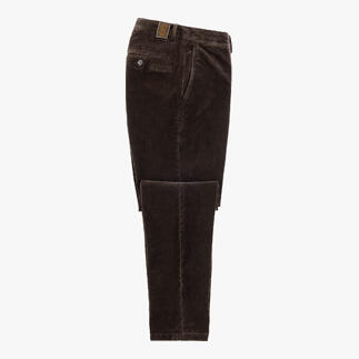 Donkerbruine fluwelen broek liggend op een tafel met een open zak.