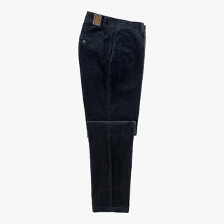 Zwarte fluwelen broek, liggend op een tafel met open zakken.