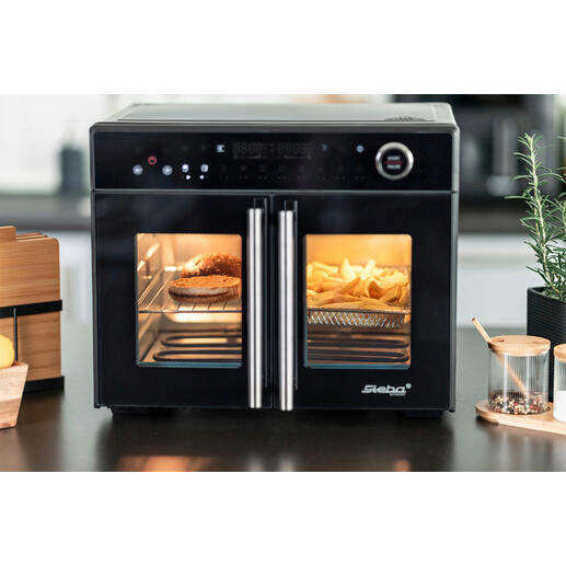 Airfry-grilloven Tri-Zone met open deuren en zichtbare frietjes.