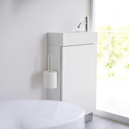 Witte design toiletrolhouder bevestigd aan een modern badkamermeubel.