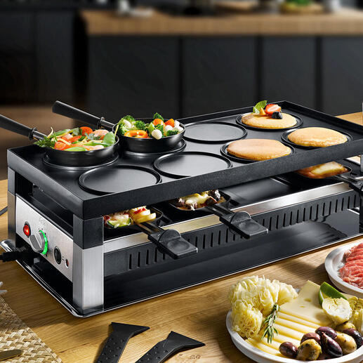 Solis raclette- en fun-koken 5-in-1 apparaat met groenten en vlees op de tafel.