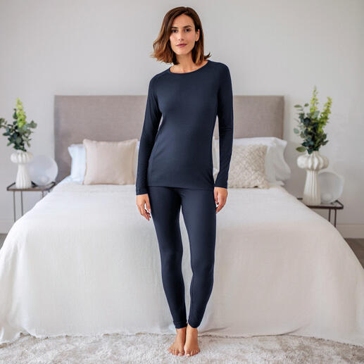 Dames pyjama shirt in donkerblauw, casual staand voor een bed.