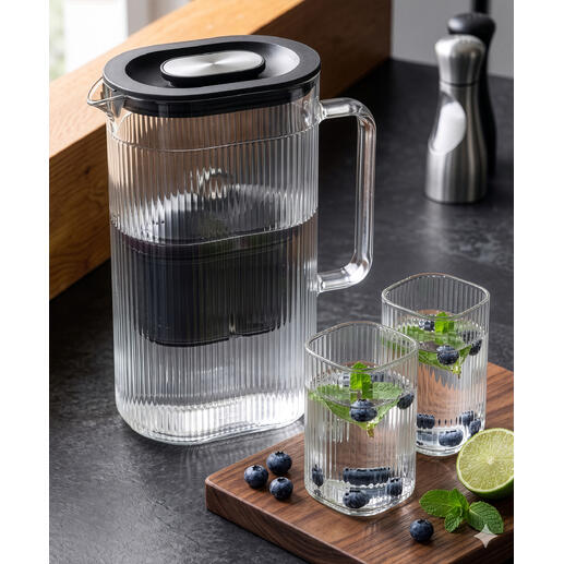 Waterfilterkaraf met extra glas en verse kruiden.