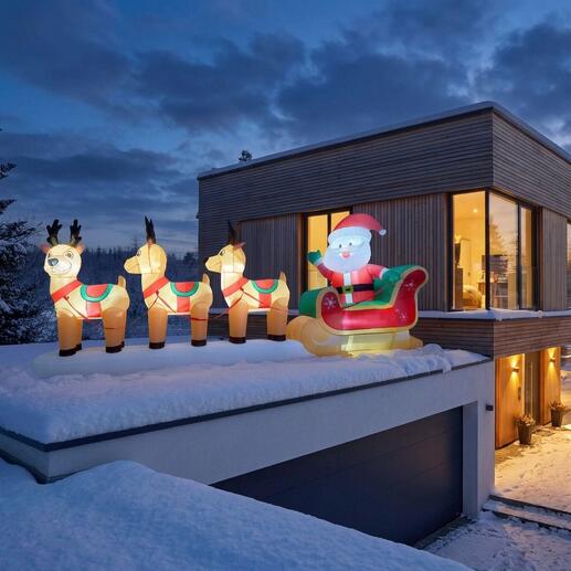 Opblaasbare rendierslee met de Kerstman op het dak van een modern huis.