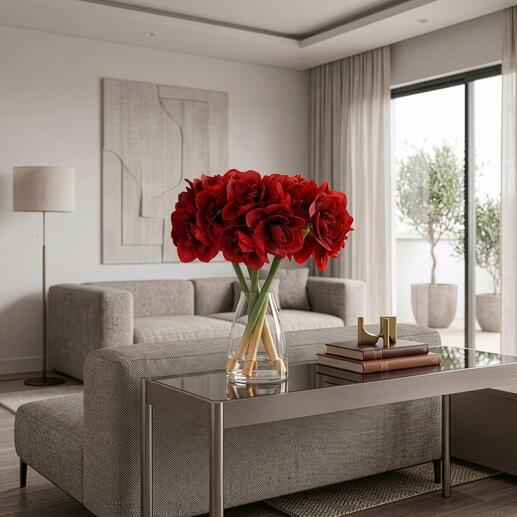 Vol amaryllis boeket in een vaas op een glazen tafel met een bank op de achtergrond.
