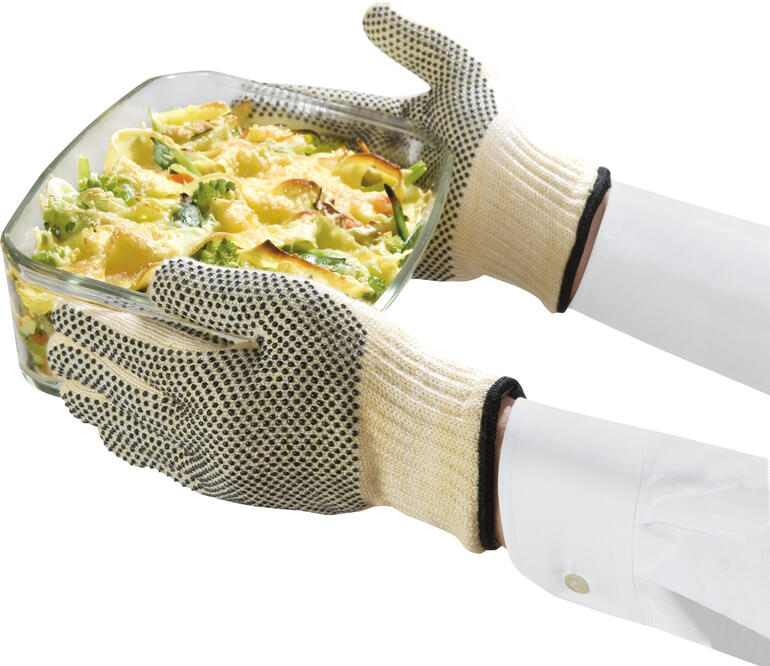 Warmtebestendige handschoenen houden een ovenschaal vast
