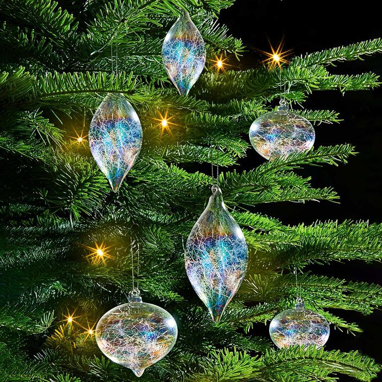 Zes iriserende glasdraden hangen als kerstversiering.