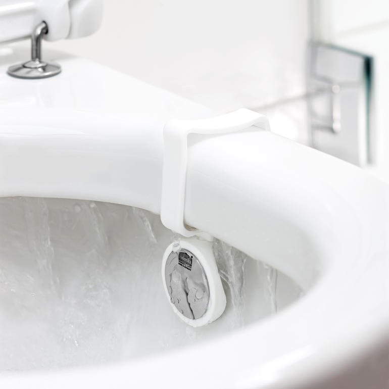 WC-geurvervanger bevestigd aan de toiletrand