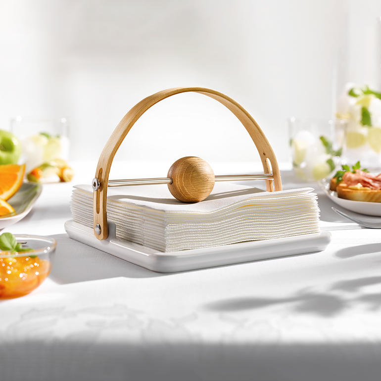 Design servettenhouder van porselein met houten boog.