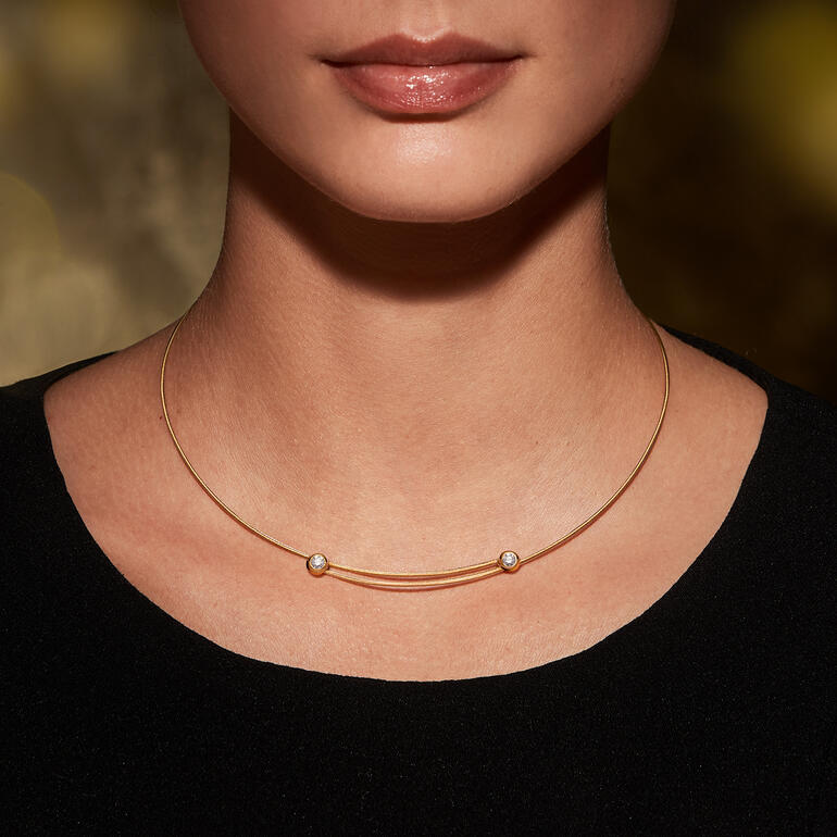Vrouw draagt gouden kabelcollier met diamanten