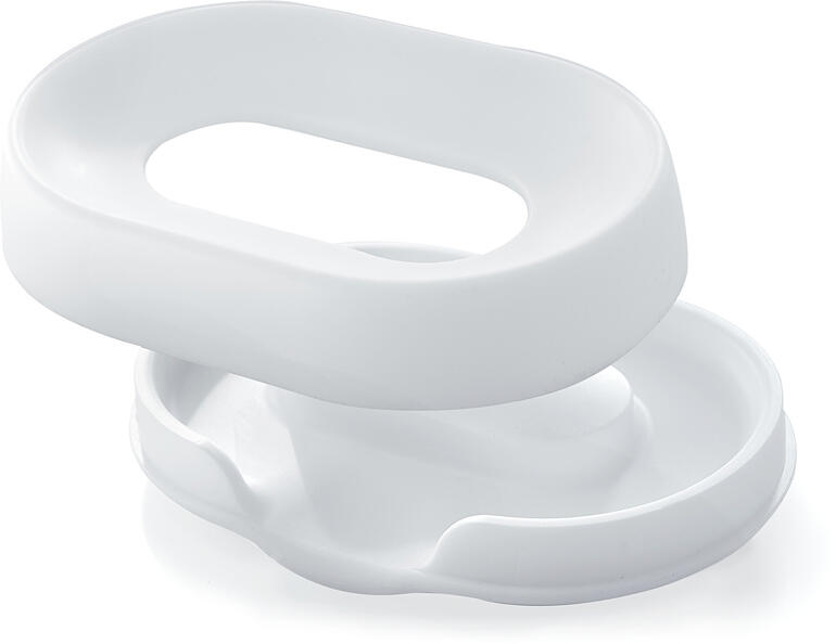 De siliconen ring en het lekbakje met geïntegreerde afvoer houden de zeep hygiënisch droog. Witte silicone zeepdispenser, van bovenaf bekeken.