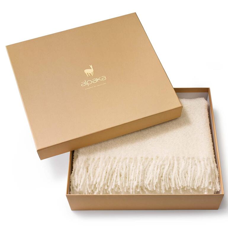 Alpaca bouclé deken in een cadeaubox.