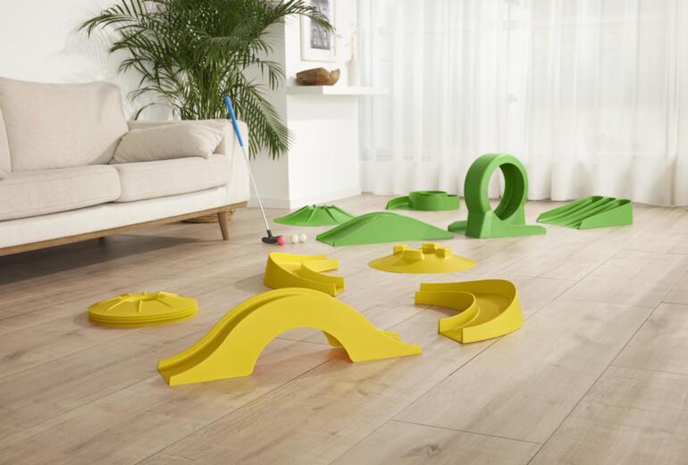 17-delig mini-golfset voor binnen, zonder baan, op een houten vloer.