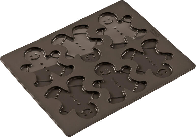 Bakvorm voor peperkoekmannetjes Peperkoekmannen-moule op een houten achtergrond.