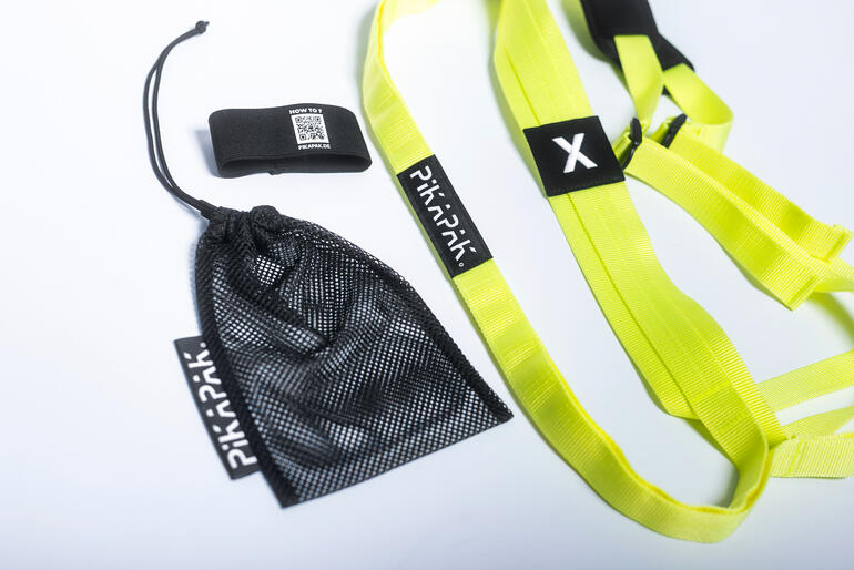 Pakketrugzak Accessoires voor een pakketrugzak, waaronder banden en een netzak.