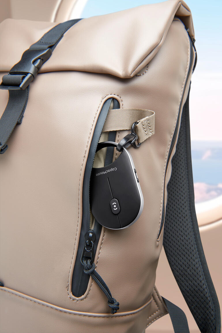 Mobiele mini-muis in een zak van een rugzak.