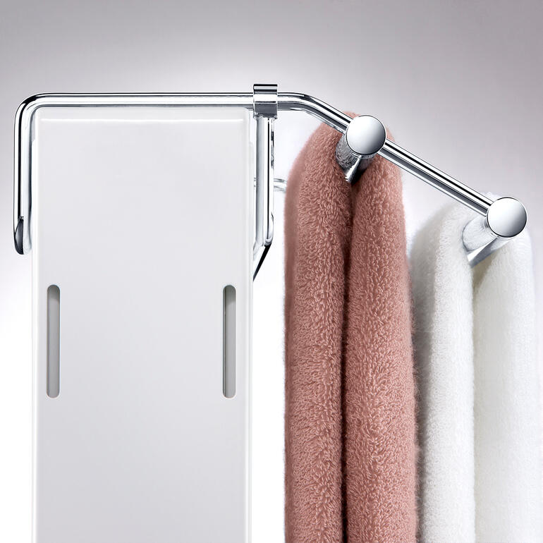 Met de traploos verschuifbare beugel past u het rekje exact aan de diepte van de radiator aan. Detailweergave van de handdoekdroger met hangende handdoeken.