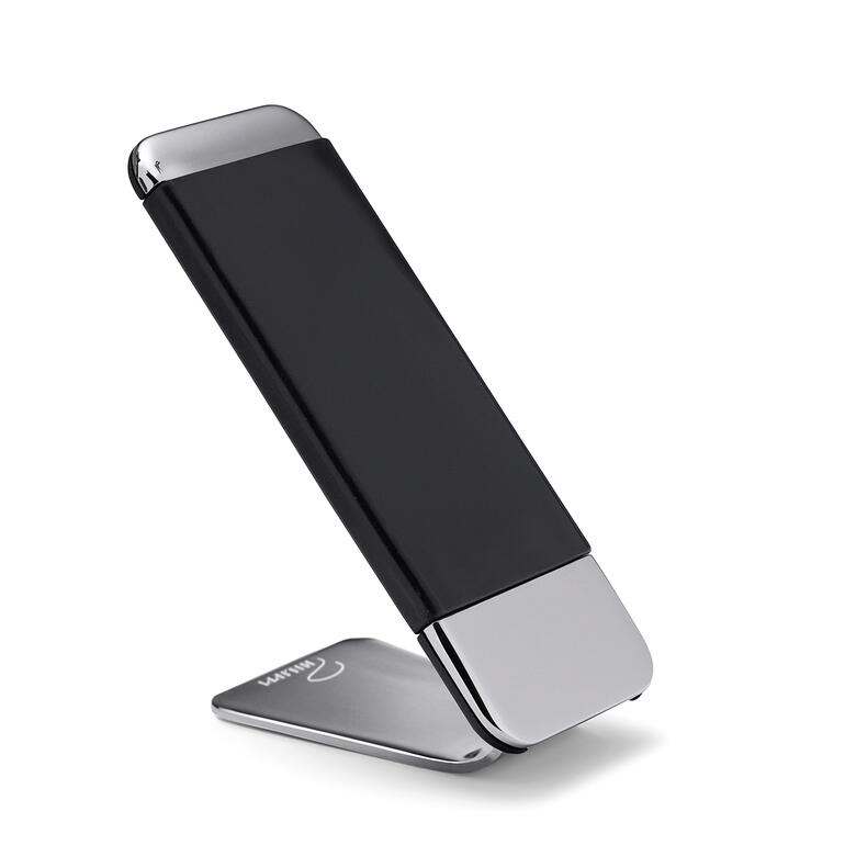 Zwarte grip telefoonhouder staande op een tafel.