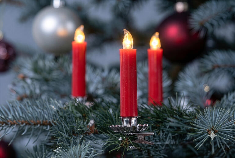 Rode LED echte wax kerstkaarsen aan een kerstboom.