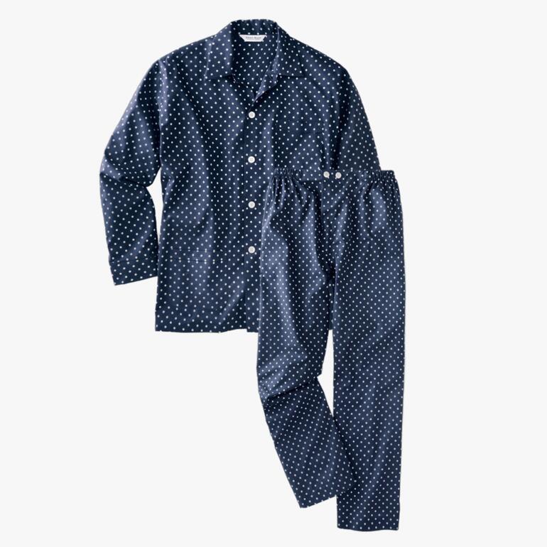 Navy blauwe pyjama met witte stippen, bestaande uit een top en broek.