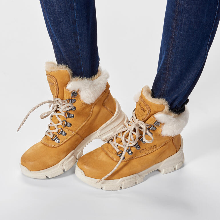 Bruine wandelschoenen met een bontkraag, gedragen door een vrouw