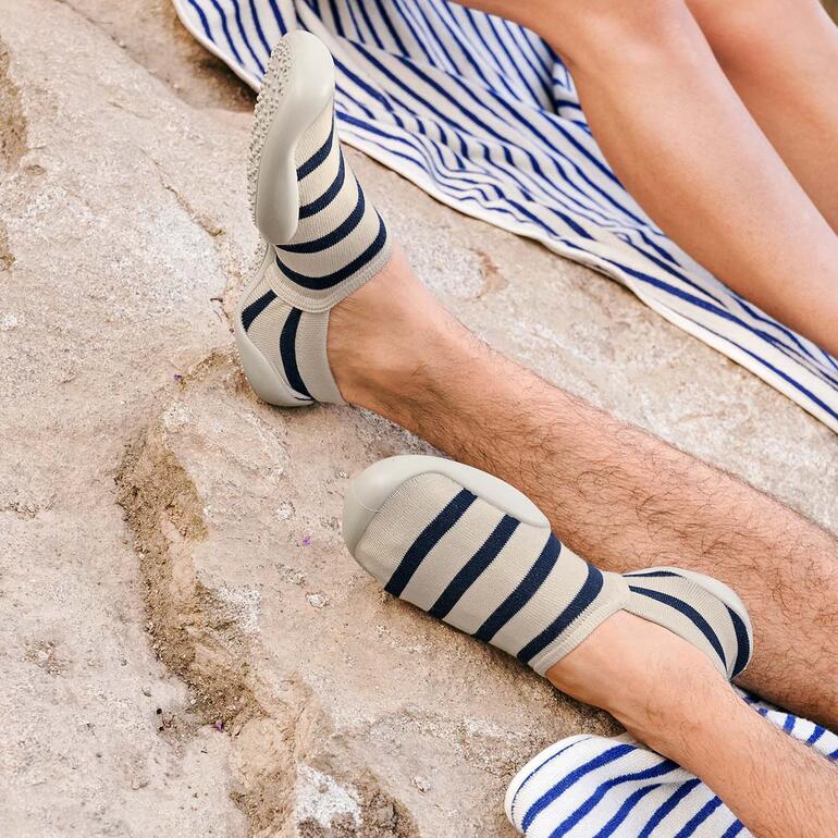 ecru/navy Gestreepte zomersokken in een zandige omgeving.