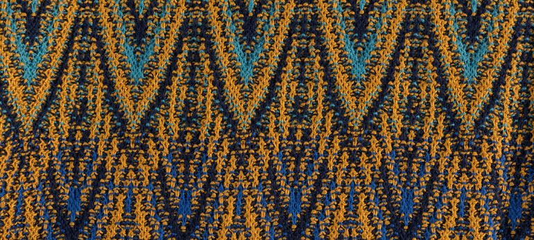 Detail van een Jacquard-patroon in blauw- en geeltinten.