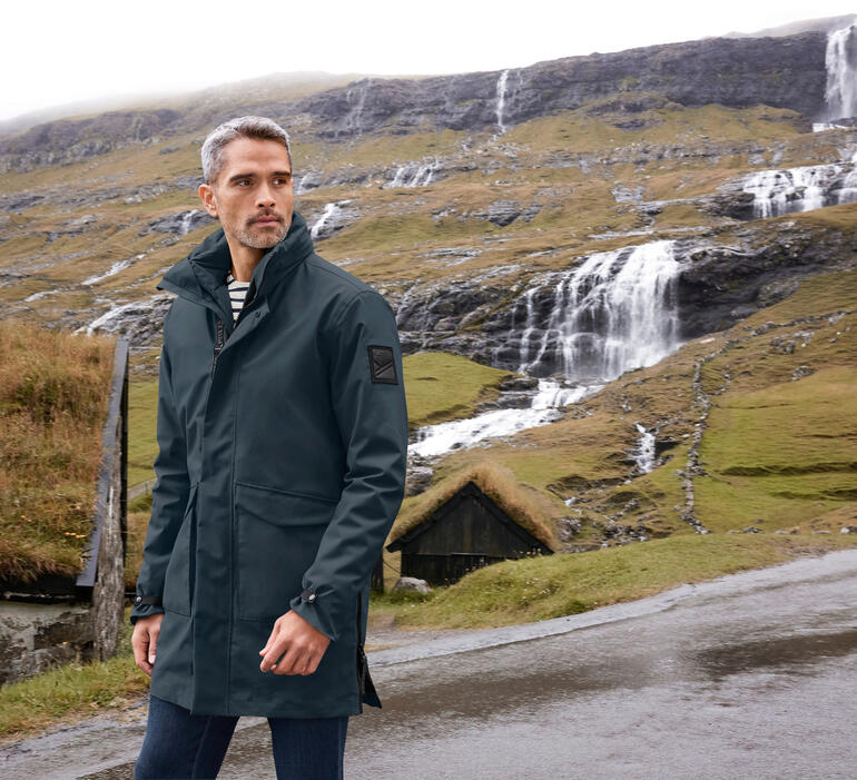 Man in 3-in-1-weerparka in een berglucht.