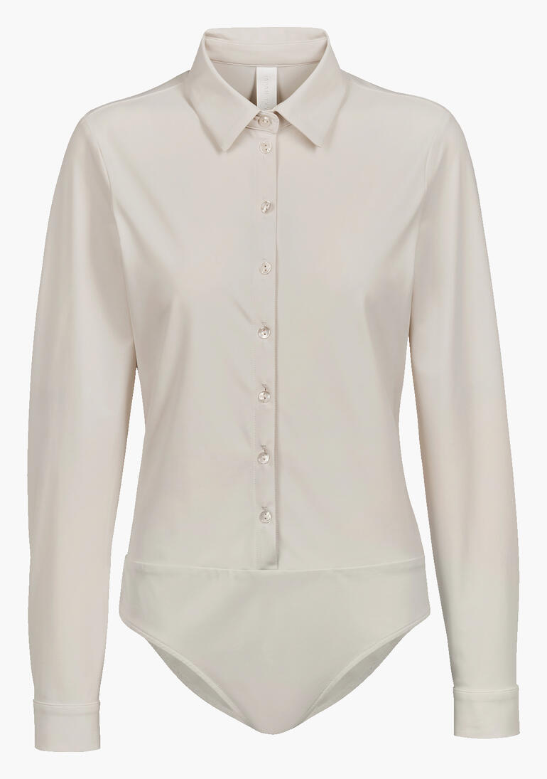 Beige blouse body met lange mouwen en knopen.