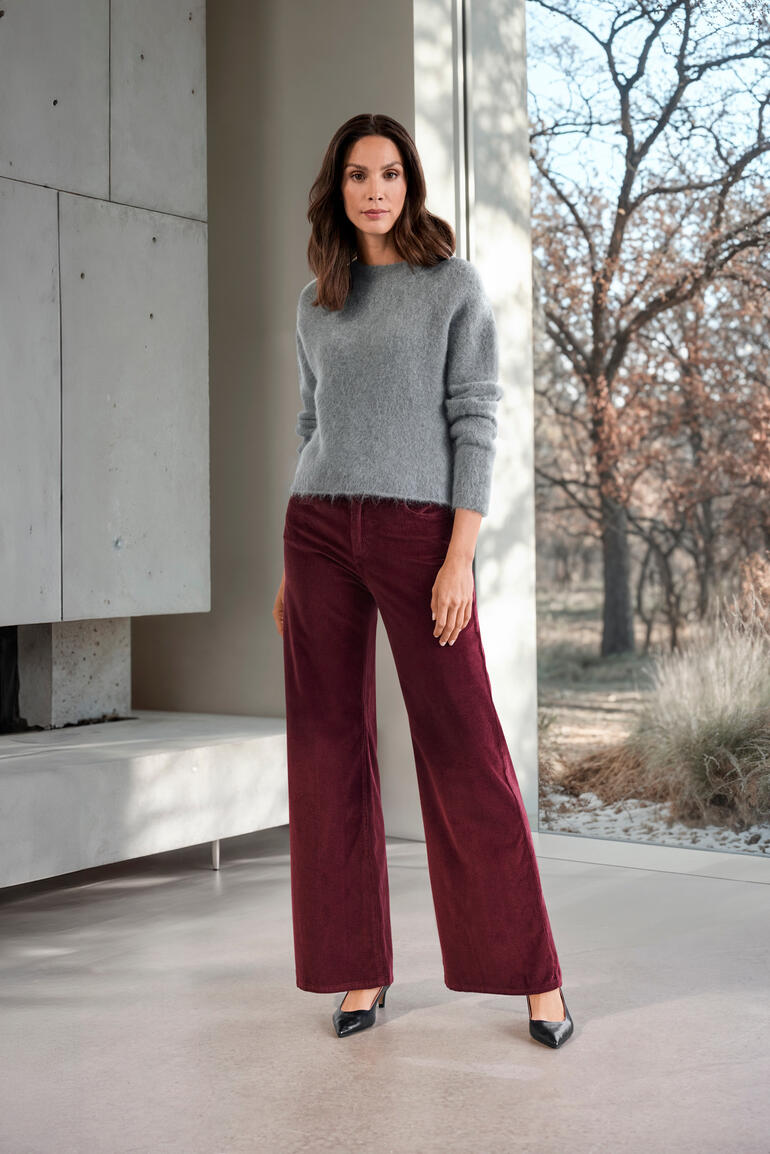 Grijze brushed alpaca trui in maat 34 op een model.