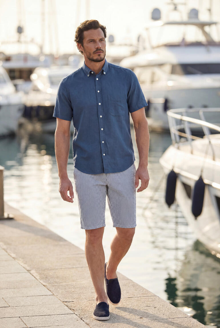 Man in marineblauw BDO-shirt en shorts loopt langs de haven.